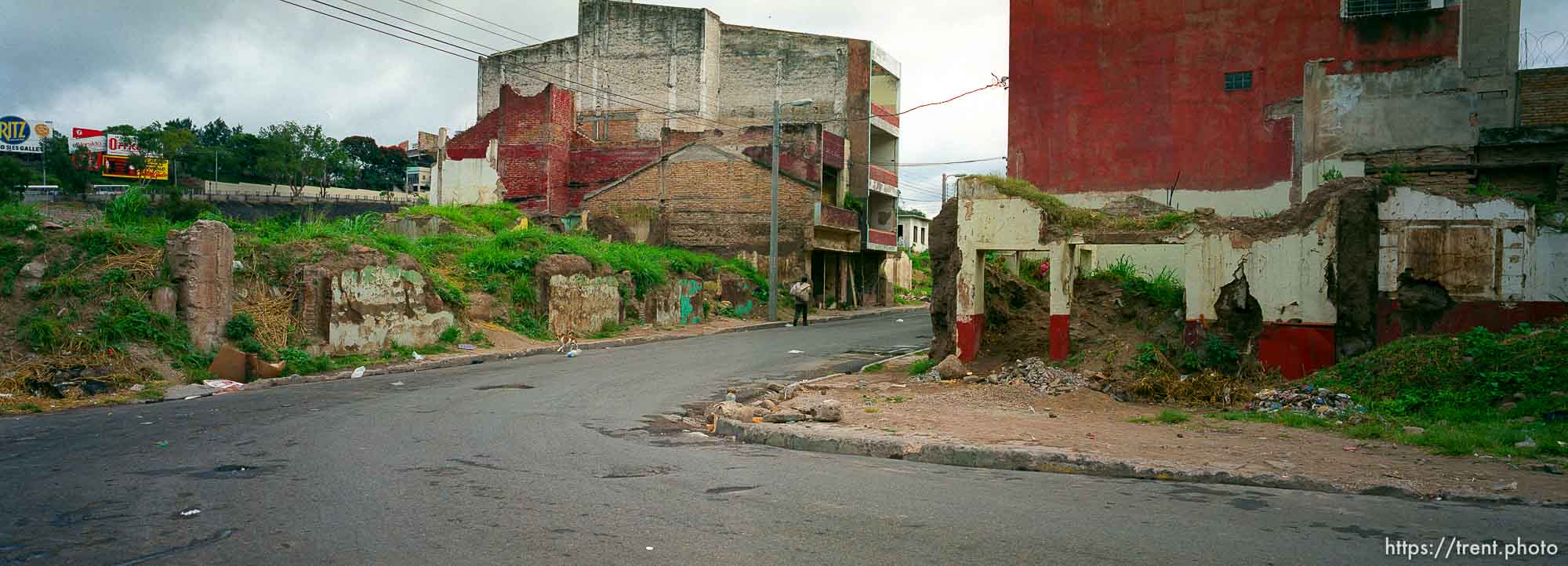 Street scene of damage done by hurricane Mitch.