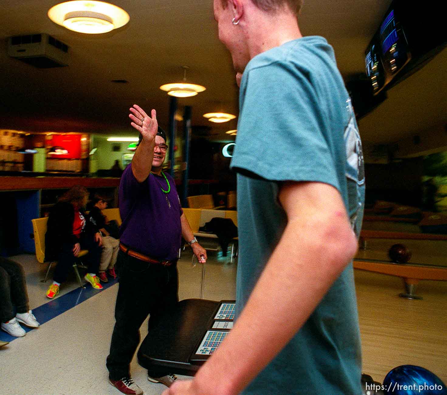 Disabled kids bowling and playing videogames.