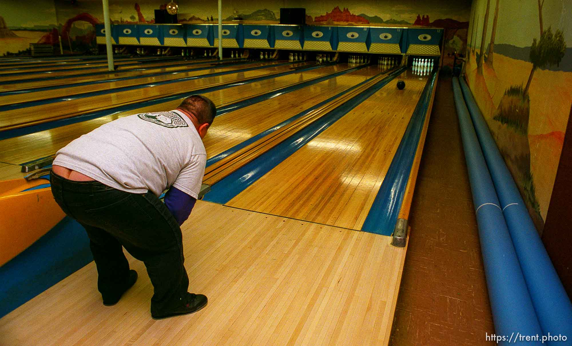 Disabled kids bowling and playing videogames. Guy bending over