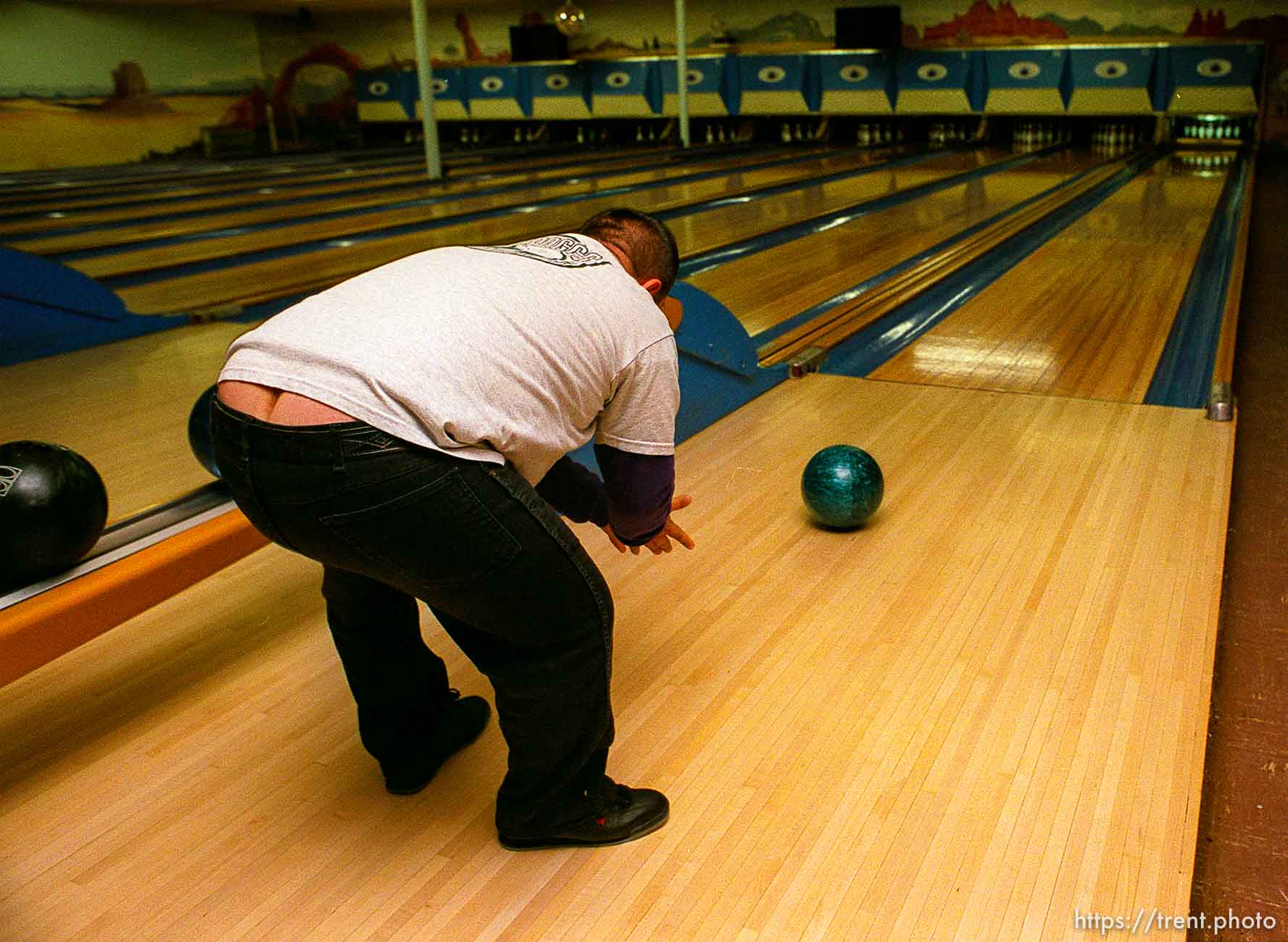 Disabled kids bowling and playing videogames. Guy bending over