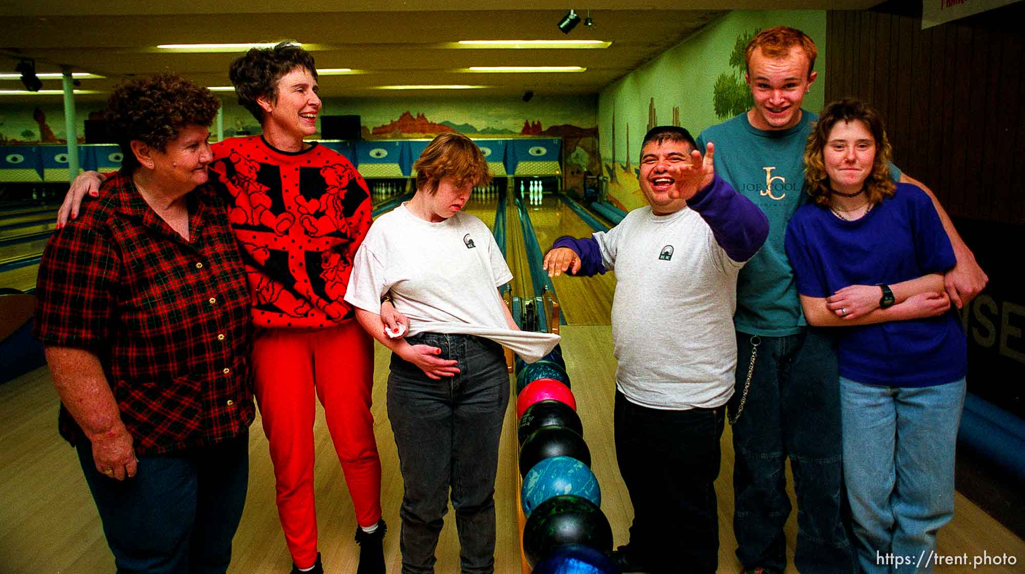 Disabled kids bowling and playing videogames. Group shot