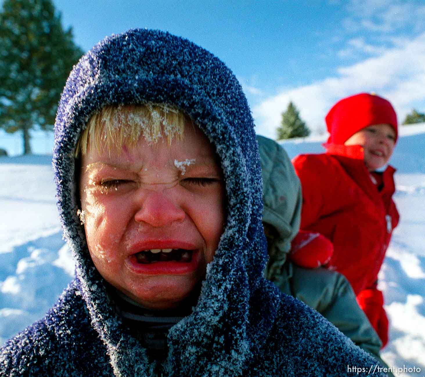 crying after being coated with snow while sledding at Sugarhouse Park.