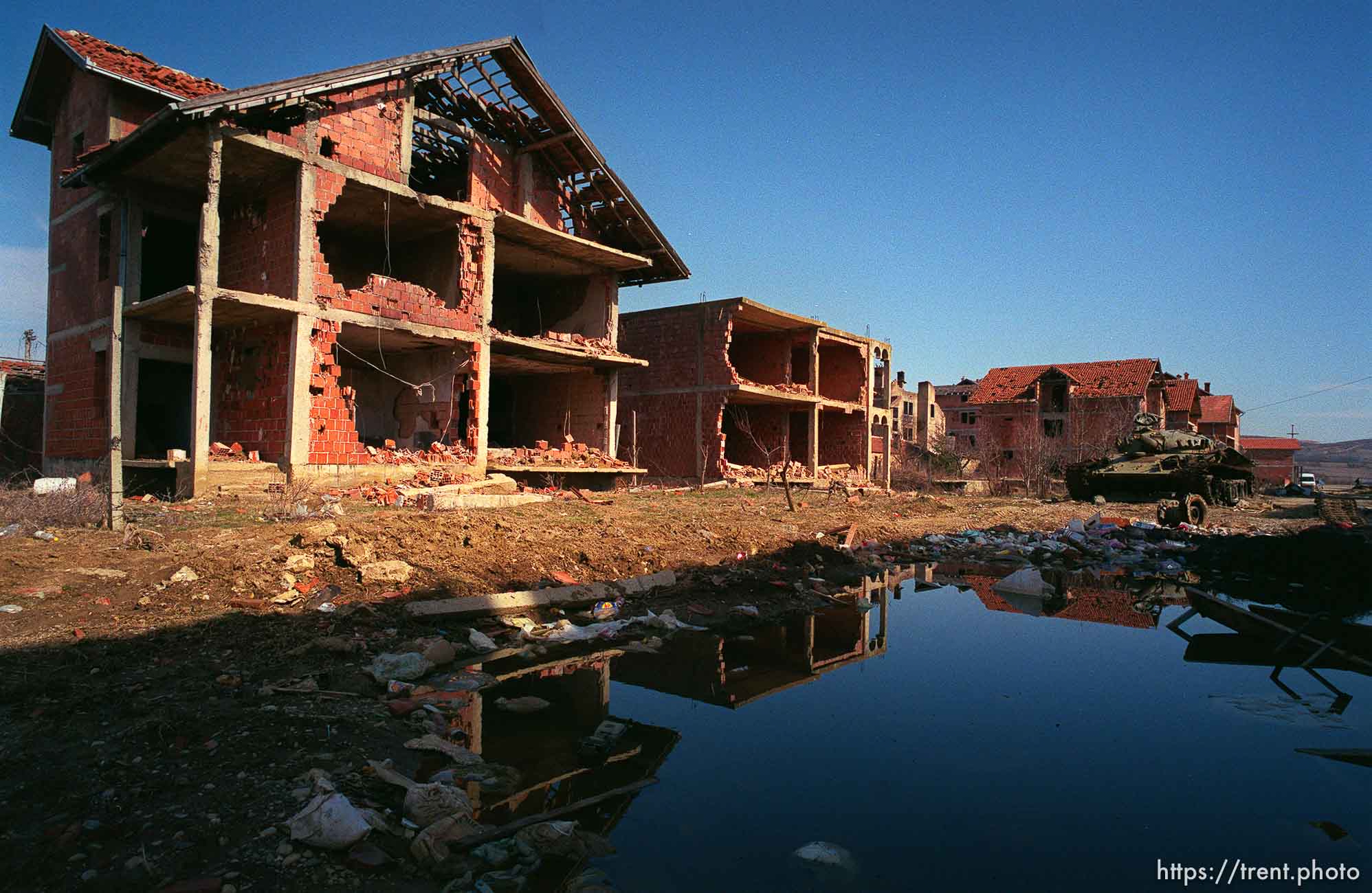 Destroyed homes and a tank, hidden among the homes