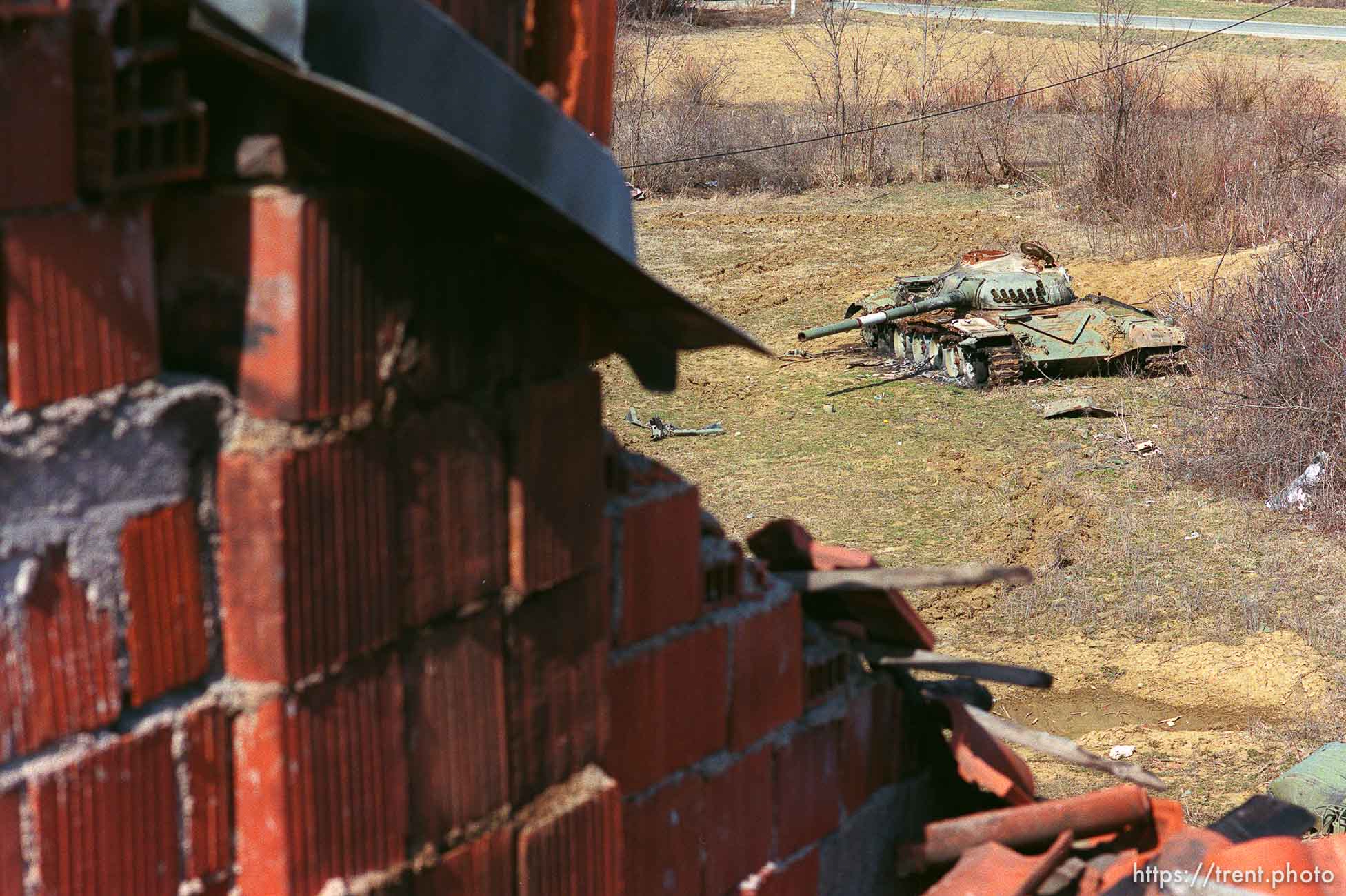 Ruins of a home and a Yugo tank.