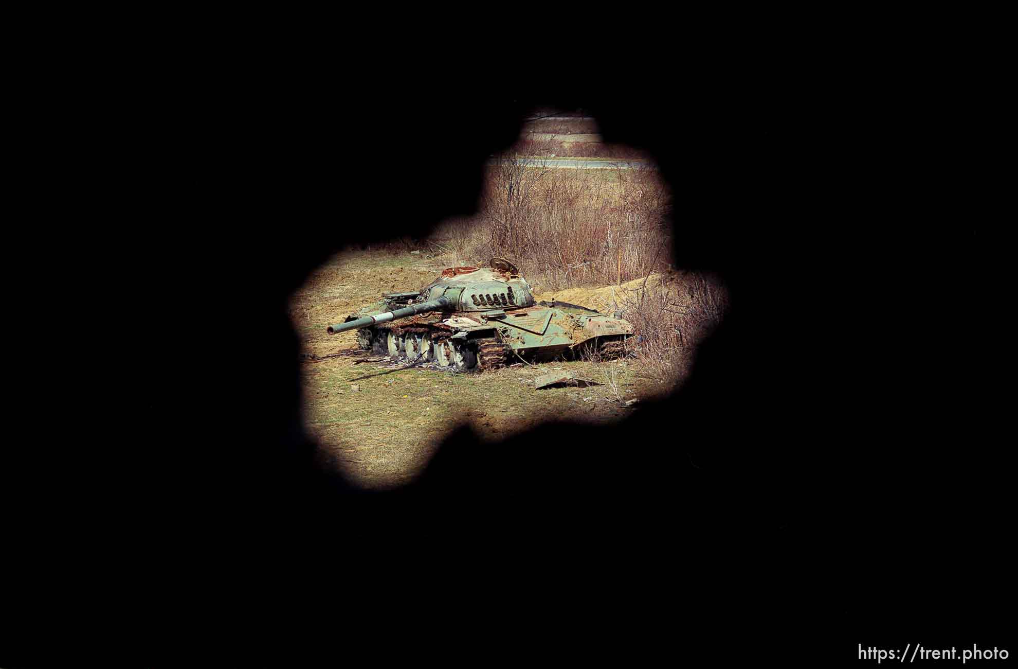 Destroyed Yugo tank, seen through a shell hole.