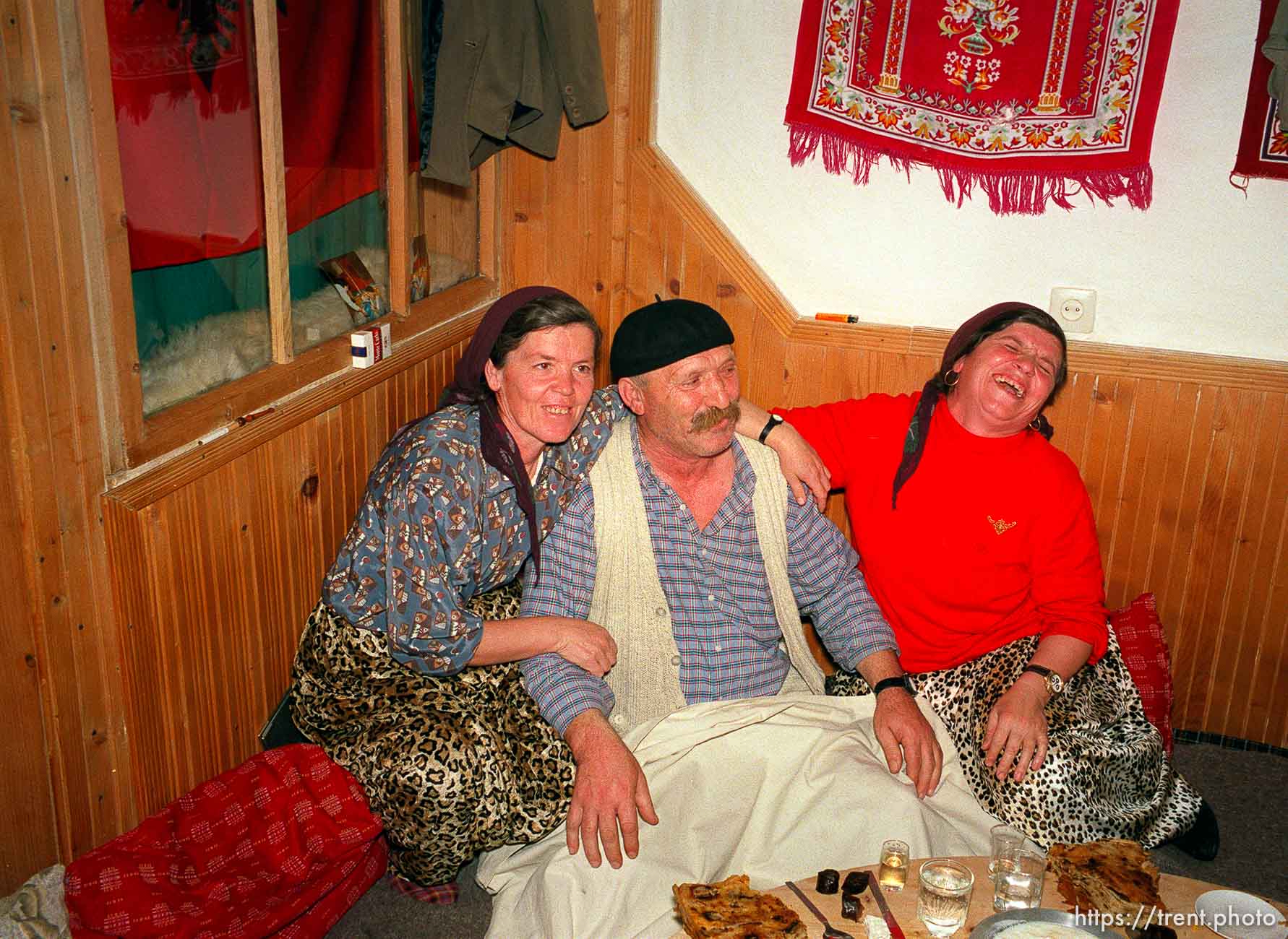 Skender Hoxha and his two wives, who are also sisters, at a traditional dinner with the Hoxha family.