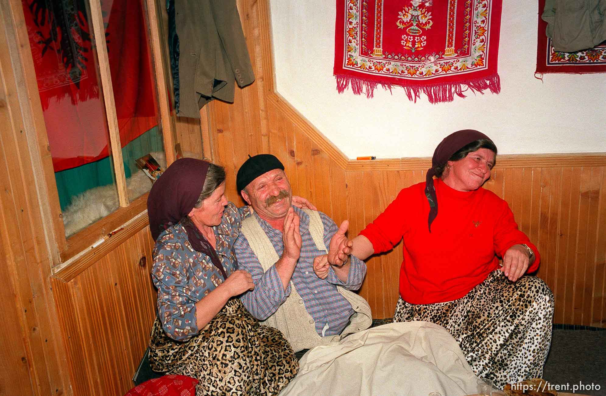 Skender Hoxha and his two wives, who are also sisters, at a traditional dinner with the Hoxha family.