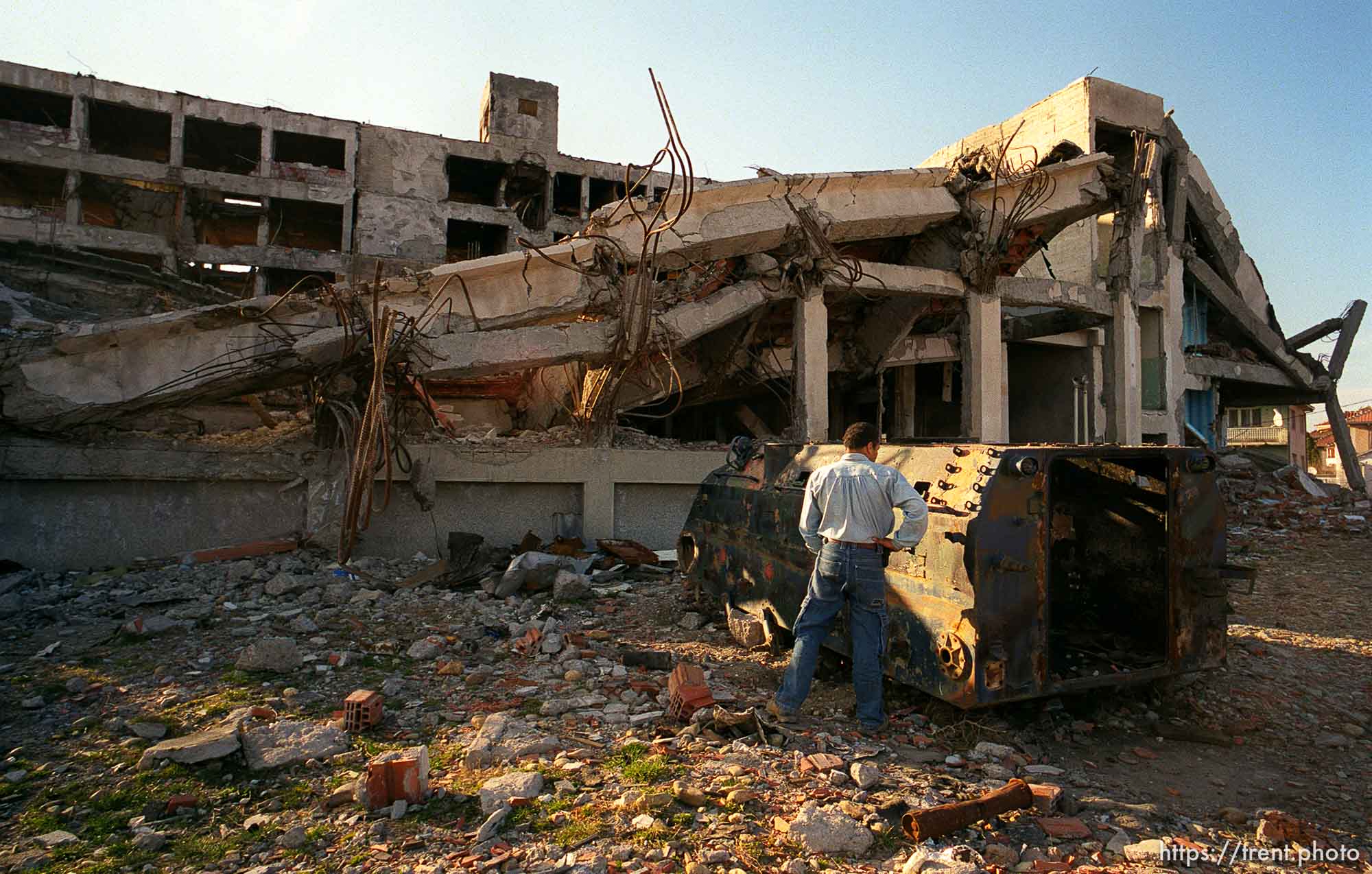 Ed Knowles urinates on a Serb police APC in front of the destroyed Serbian MUP police station.