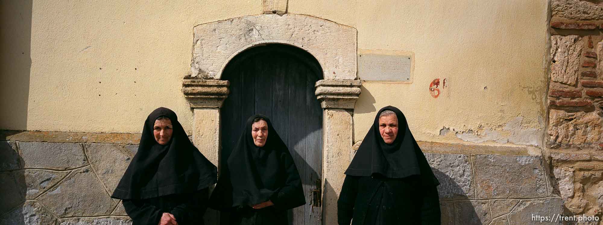 Three Serbian nuns in front of their 14th century church.