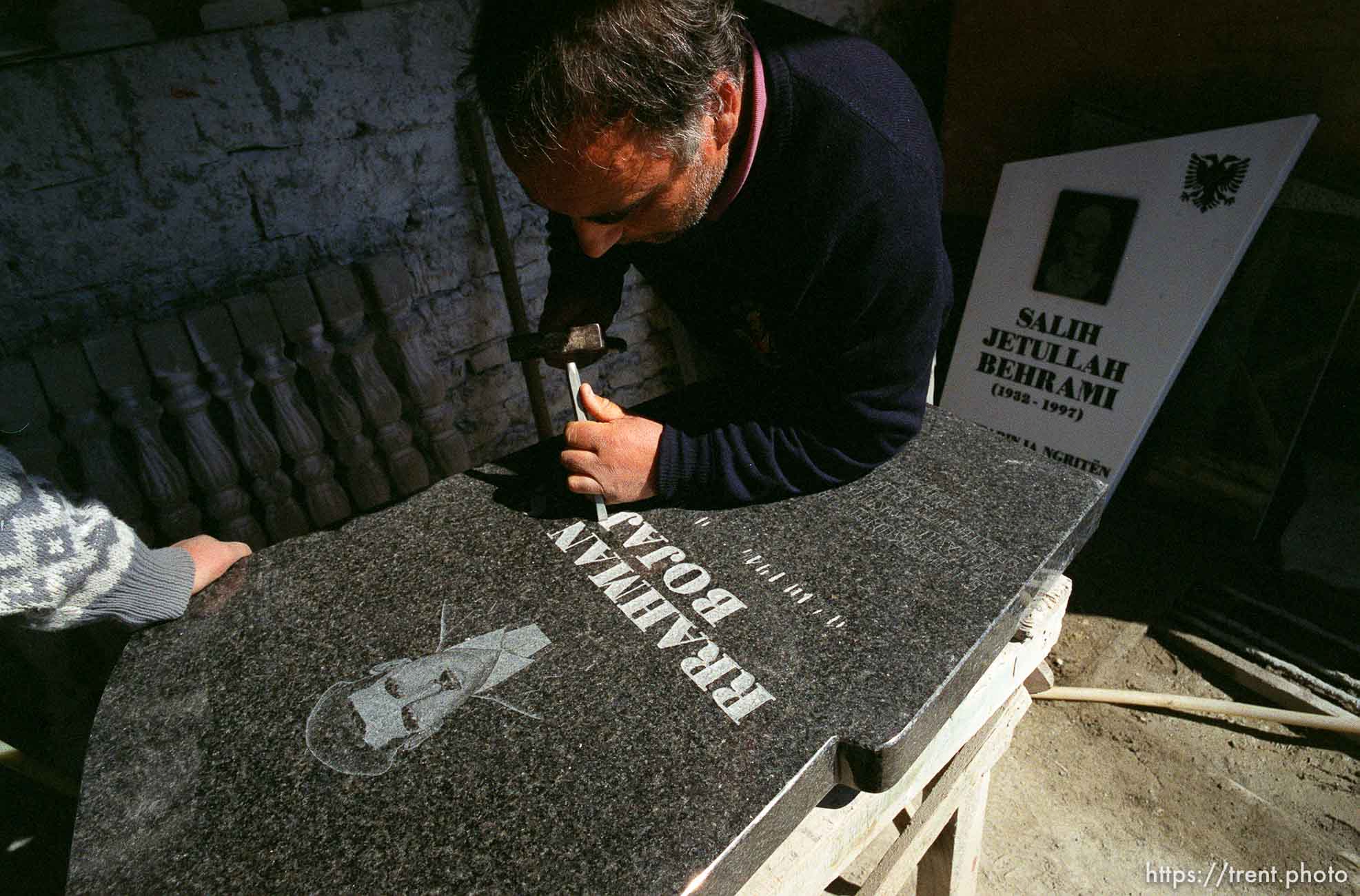 Avdi Shala carves a gravestone.