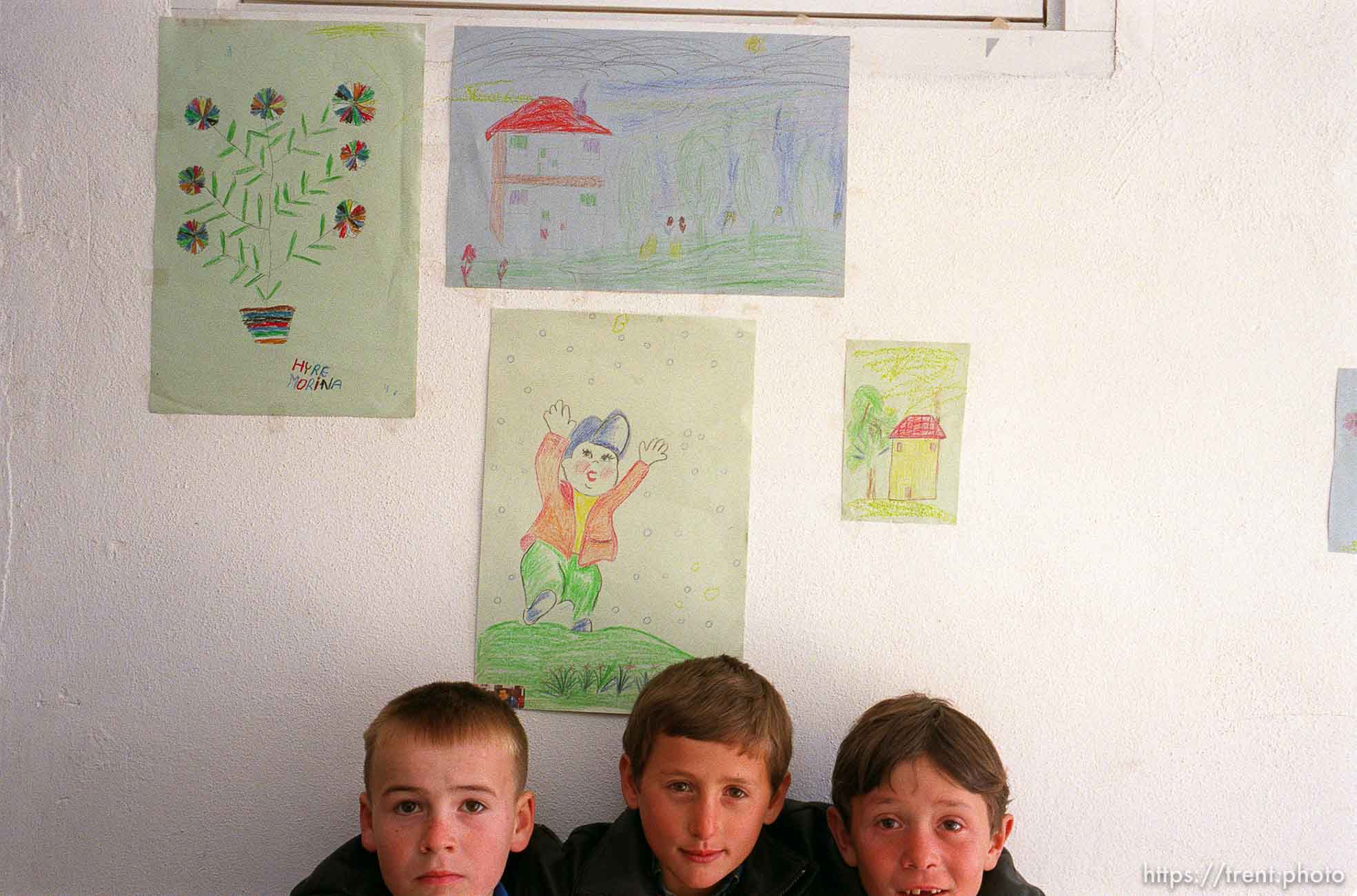 Albanian kids in the Collective Center Shelter with artwork they have drawn (not necessarily these kids)