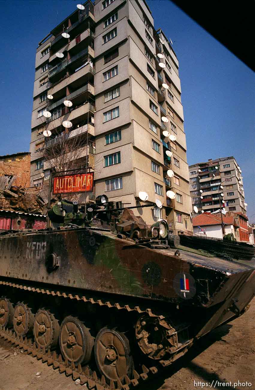 KFOR armored vehicle and a high-rise in north Mitrovica