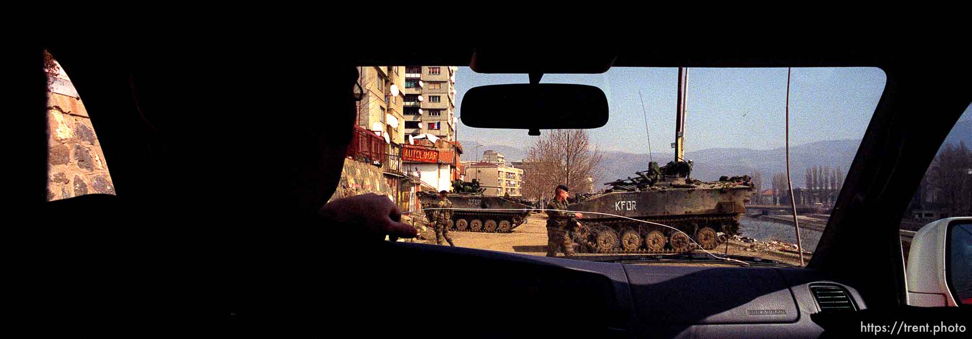 UNMIK police officer Zane Smith driving through a KFOR checkpoint in north Mitrovica.