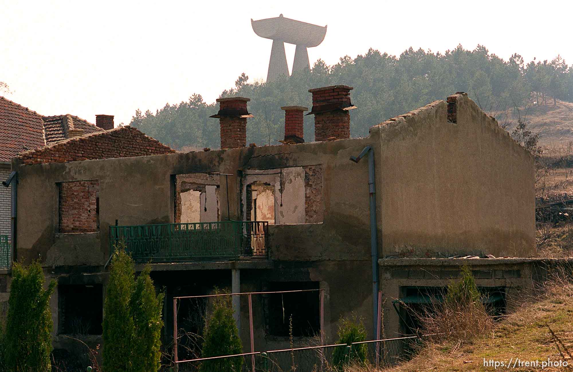 Destroyed buildings in North Mitrovica. Monument to miners on the hill.