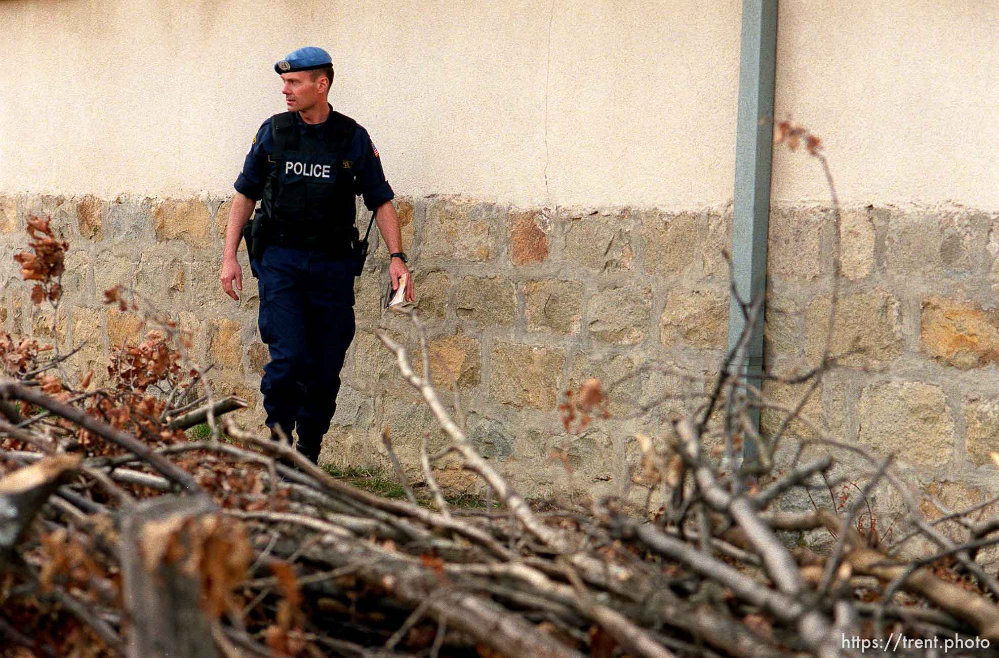 UNMIK police officer Zane Smith walking through a hillside village in Northern Kosovo