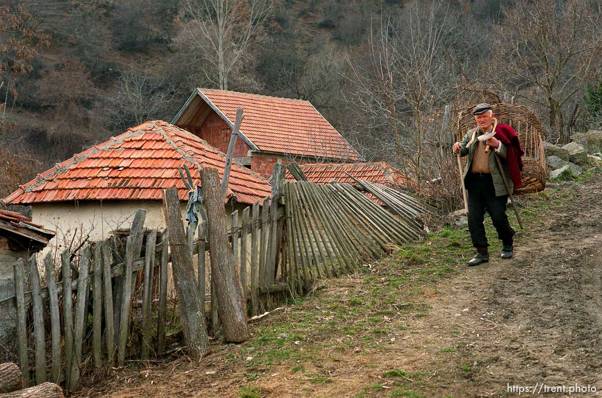 Serbian man walking down a road in a hillside village in Northern Kosovo