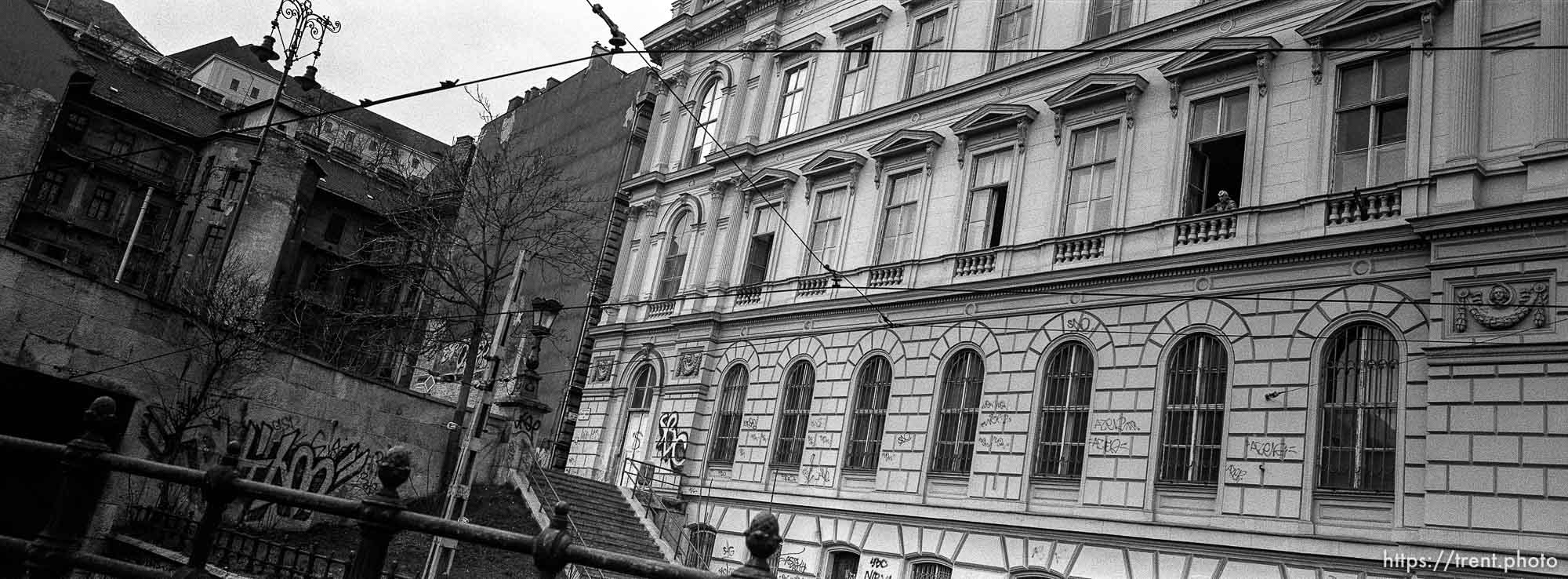 Man looking out window of building.