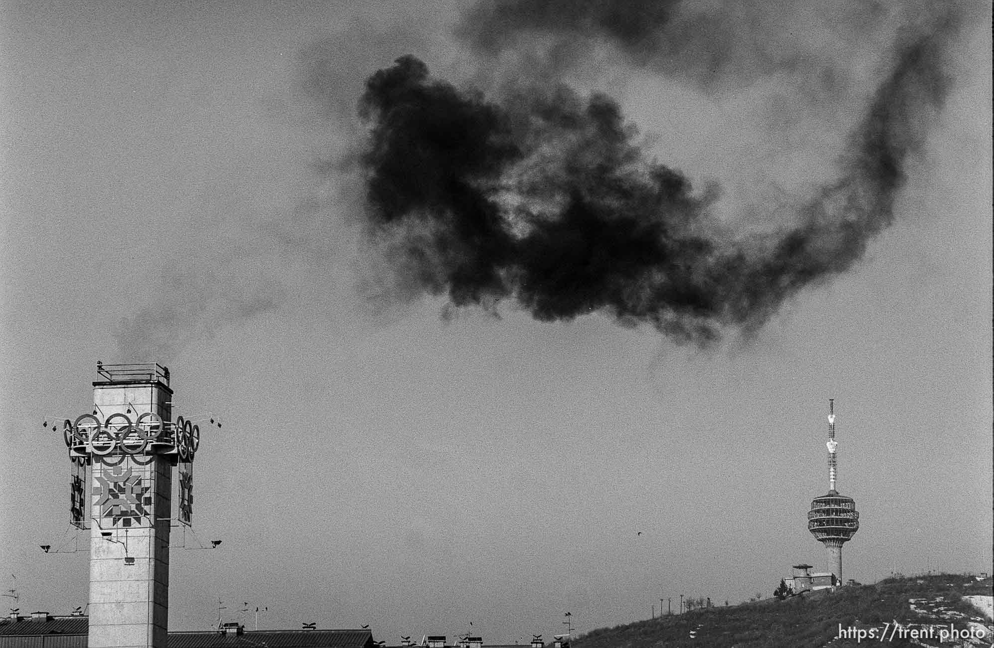 Olympic tower, black smoke, and a tower.