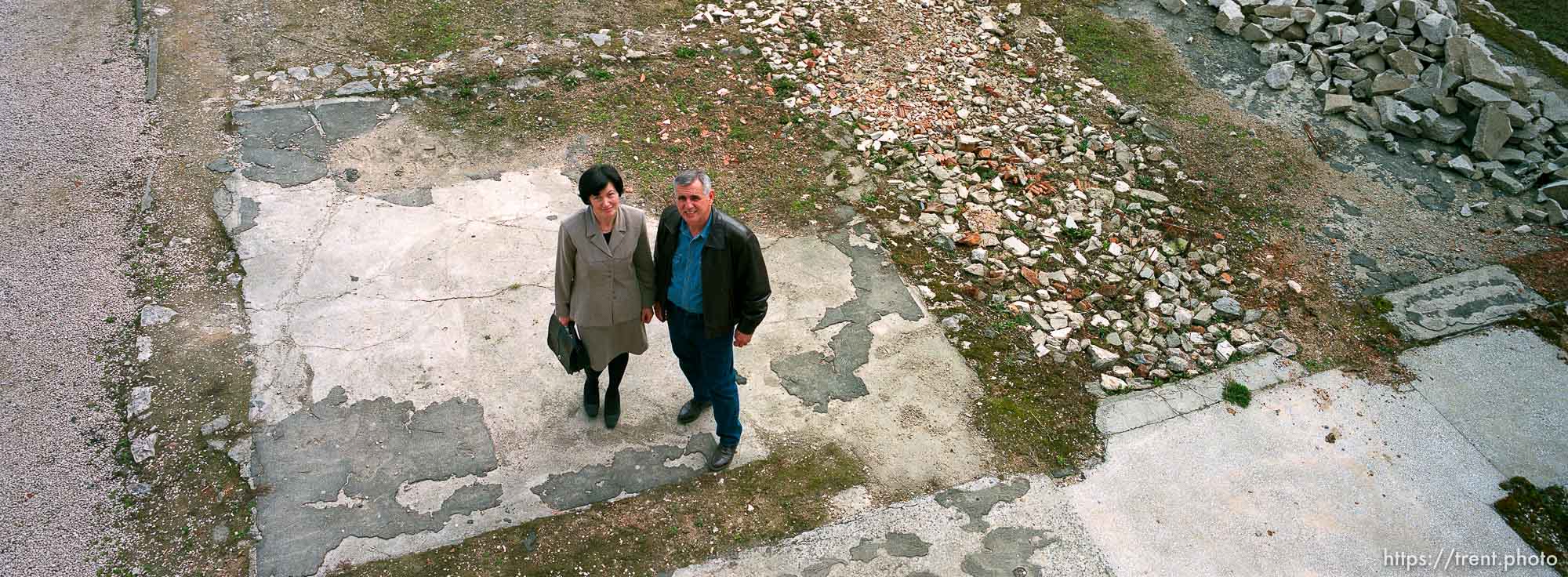 Fatima and Redzo Kurbegovic standing in the remains of their home, destroyed by Serbs during the war.