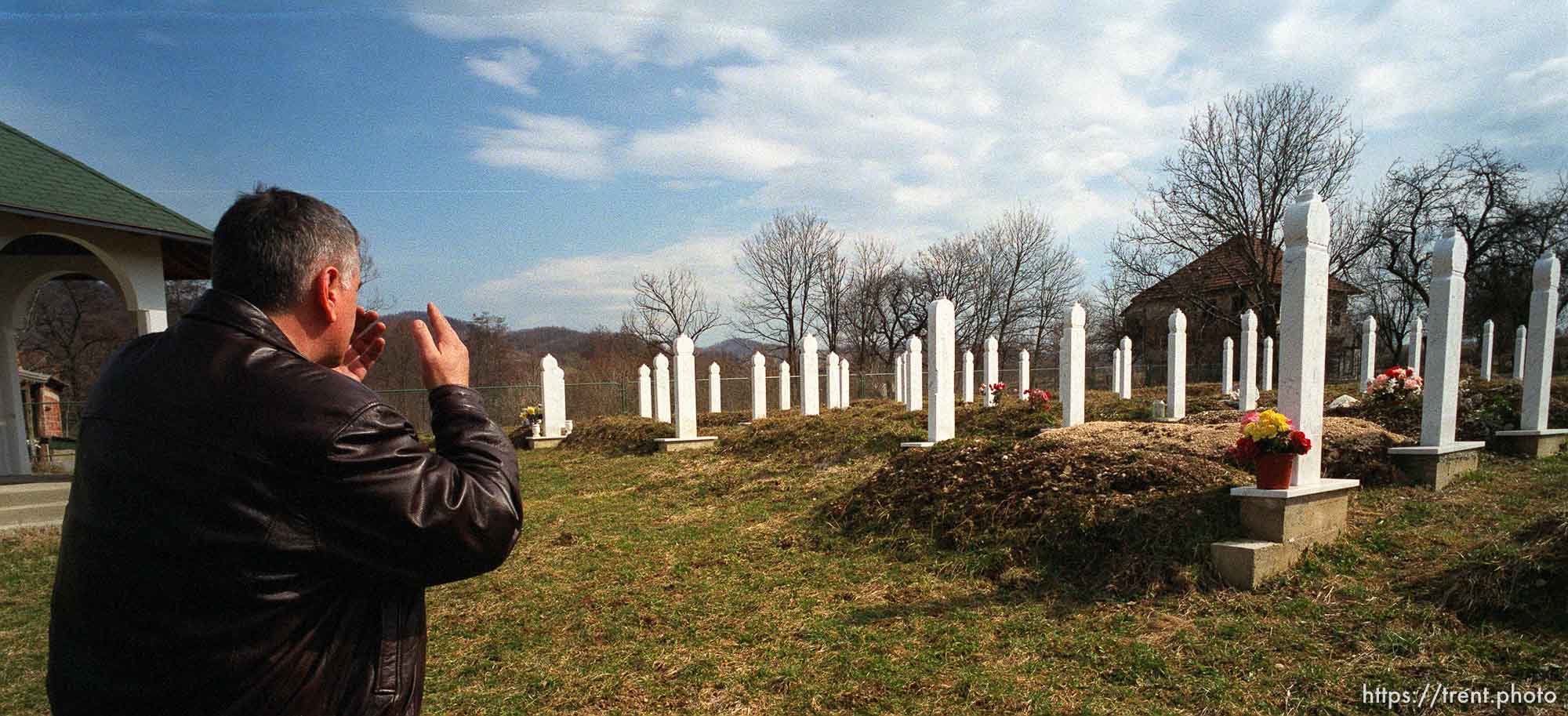 Redzo Kurbegovic offers a prayer as he leaves a cemetery and memorial for the victims of a massacre by Serbs.