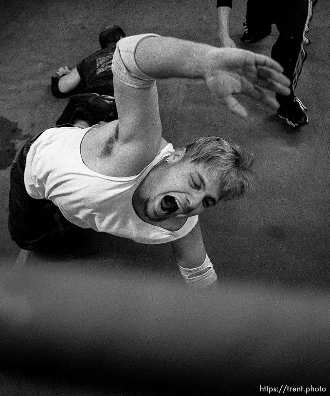 Rick Slusher reaches for the safety of the ropes during a practice match at the professional wrestling school in Orem, run by wrestler Steve Gatorwolf. photo by Trent Nelson. 11/29/2000