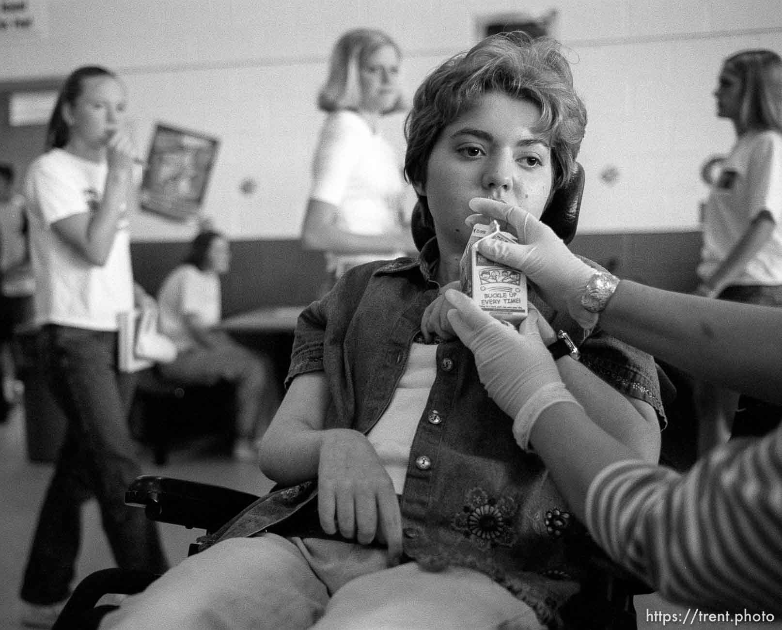 Suzanne Yelton, a special needs teacher assistant, feeds lunch to Michelle Salisbury.