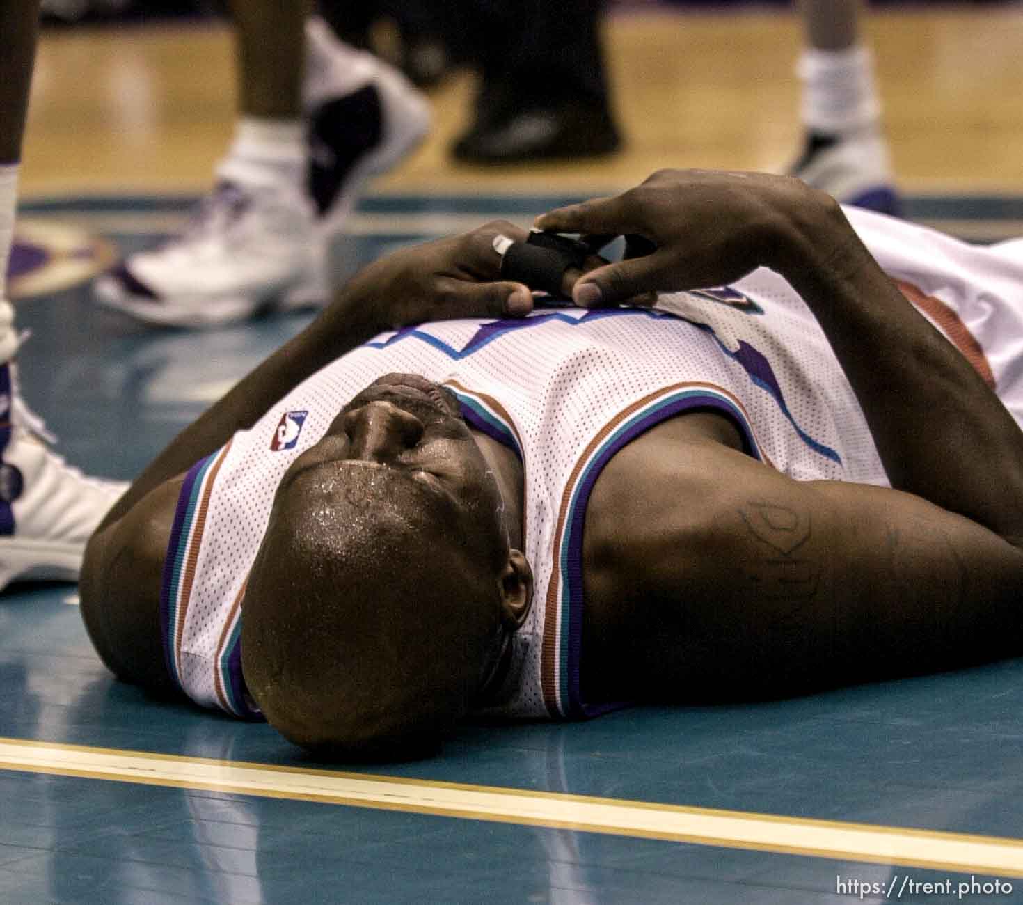 Olden Polynice on the floor as the Utah Jazz face the Dallas Mavericks in game five of their first round playoff series, in Salt Lake City Thursday.  05/03/2001