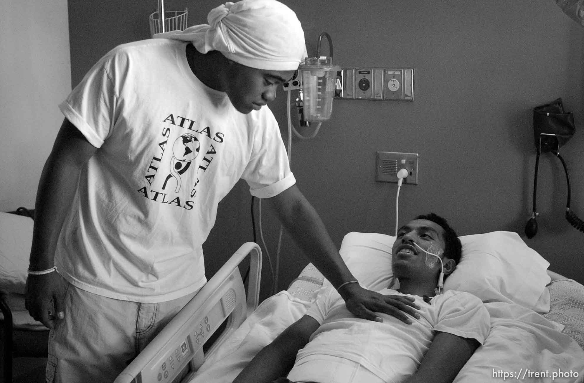 Siaosi Vainuku, a teammate of Una Taufa's at West High School, reaches out to touch his chest during a visit to LDS Hospital. West High football player Una Taufa suffered a severe neck injury in a game two weeks ago and is partially paralyzed. He has begun the long and arduous rehabilitation process at LDS Hospital.. 09/27/2001, 12:03:53 PM