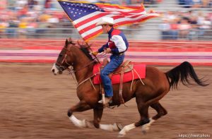 US american flag enters and leaves the arena. West Jordan's Western Stampede rodeo. After 50 years in West Jordan, voters rejected a proposition for a new rodeo grounds, putting the future of the event in question