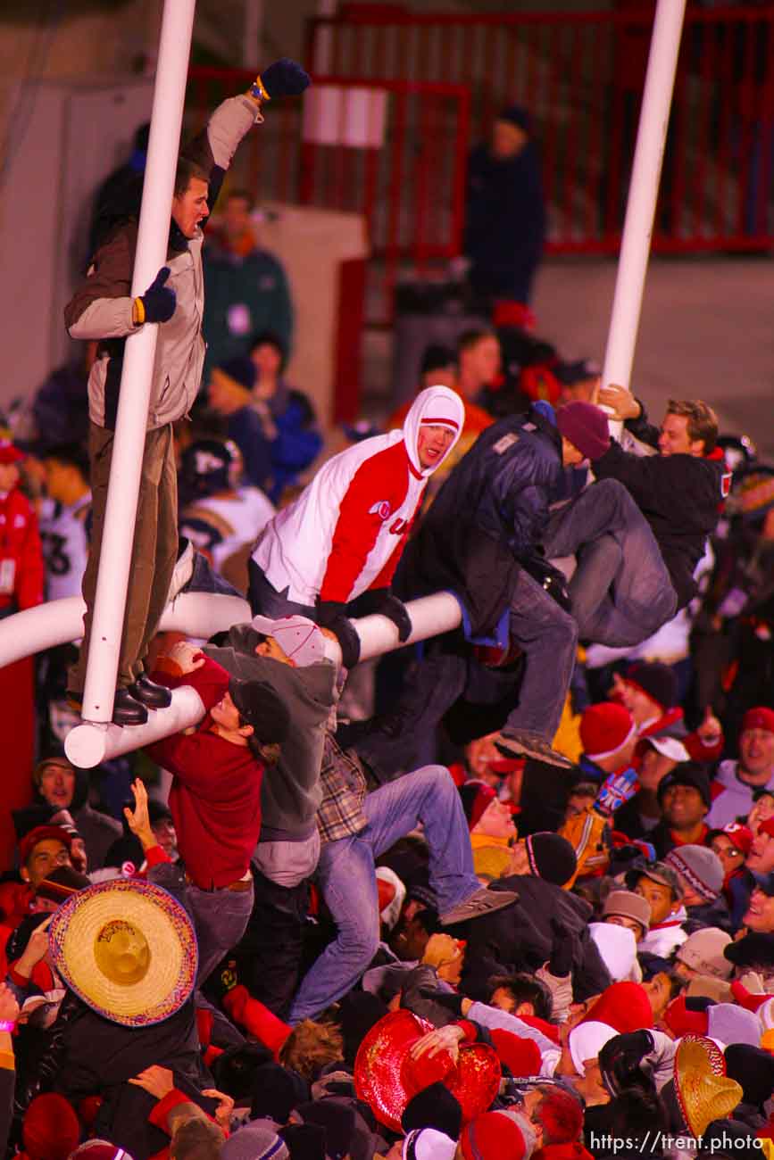 Utah fans swarm the field and down the goalposts. Utah vs. BYU college football.
11.20.2004