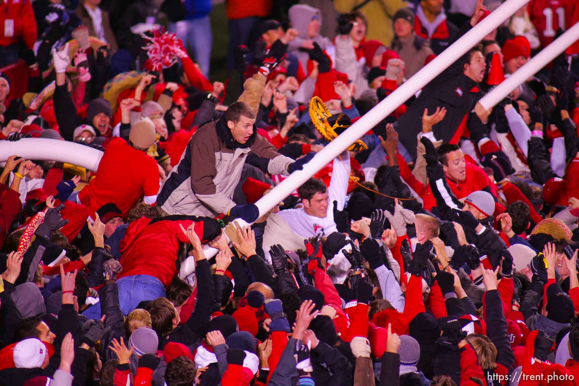 Utah fans swarm the field and down the goalposts. Utah vs. BYU college football.
11.20.2004