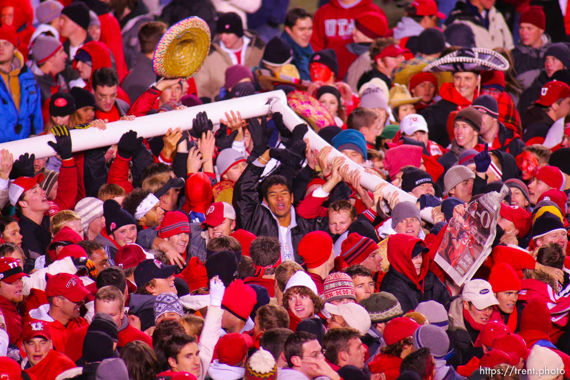 Utah fans swarm the field and down the goalposts. Utah vs. BYU college football.
11.20.2004