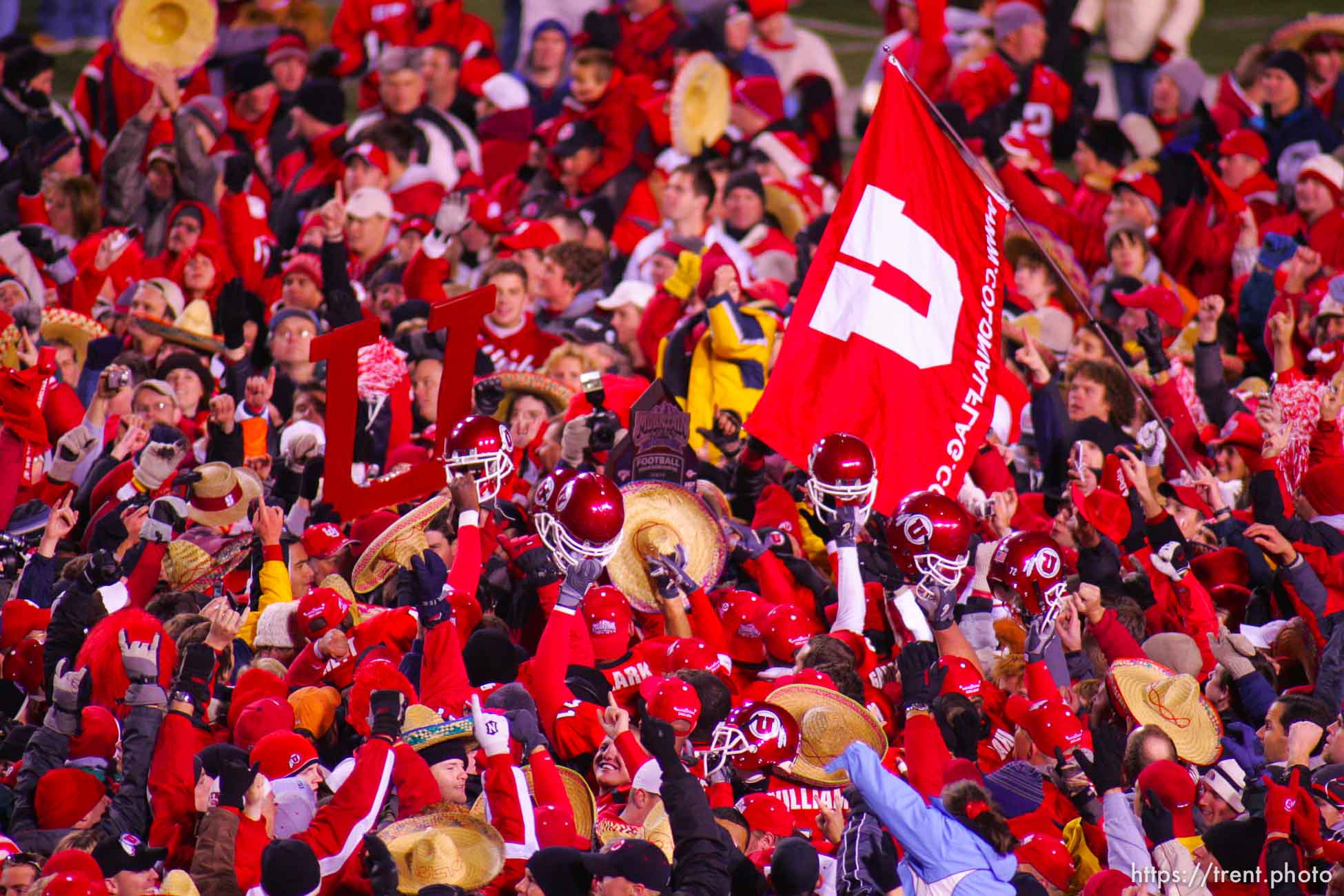 Utah fans swarm the field and down the goalposts. Utah vs. BYU college football.
11.20.2004