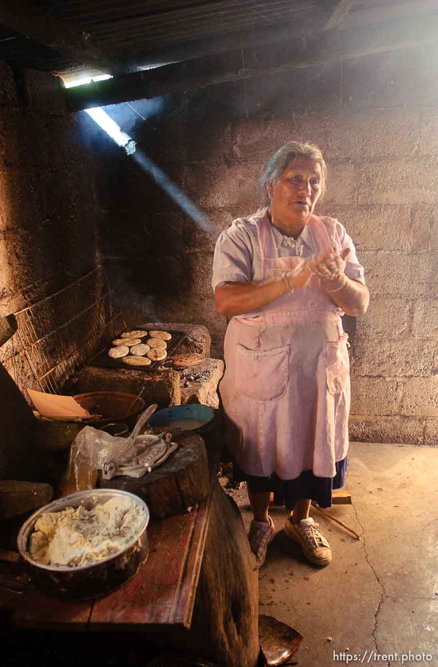 Socorro Avila Morales makes papusas. Morales's children working in Utah have helped her afford to build a newer home than she previously lived in; 12.02.2004