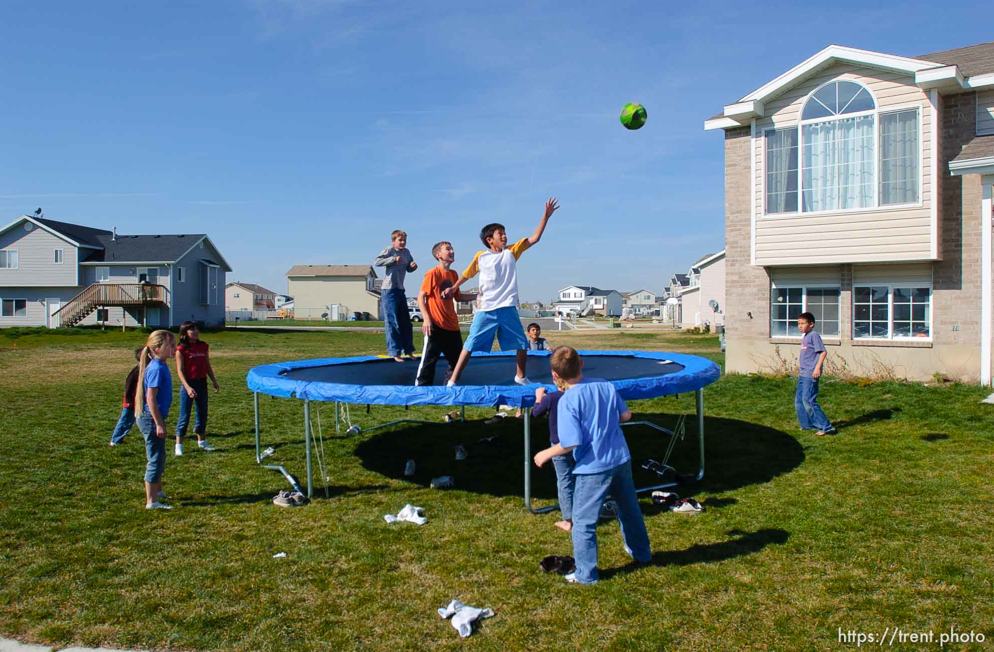 kids on trampoline in suburban homes and farmland. Davis County project. 04/06/2005