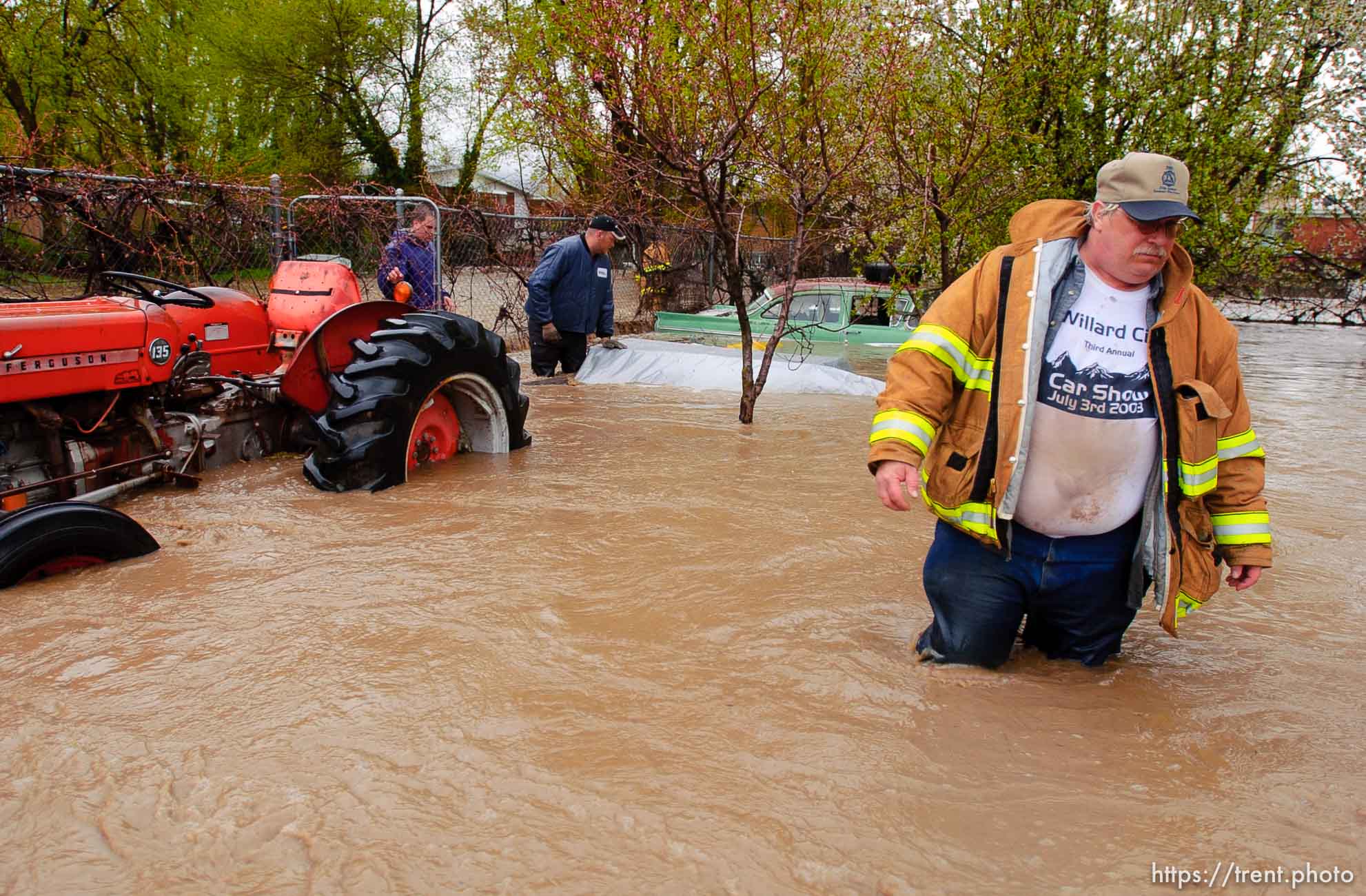 Volunteers work to save the Brigham City home of Linda and Arlin Kay as rain and melting snowpack raise the levels of Box Elder Creek and the Logan River. flood