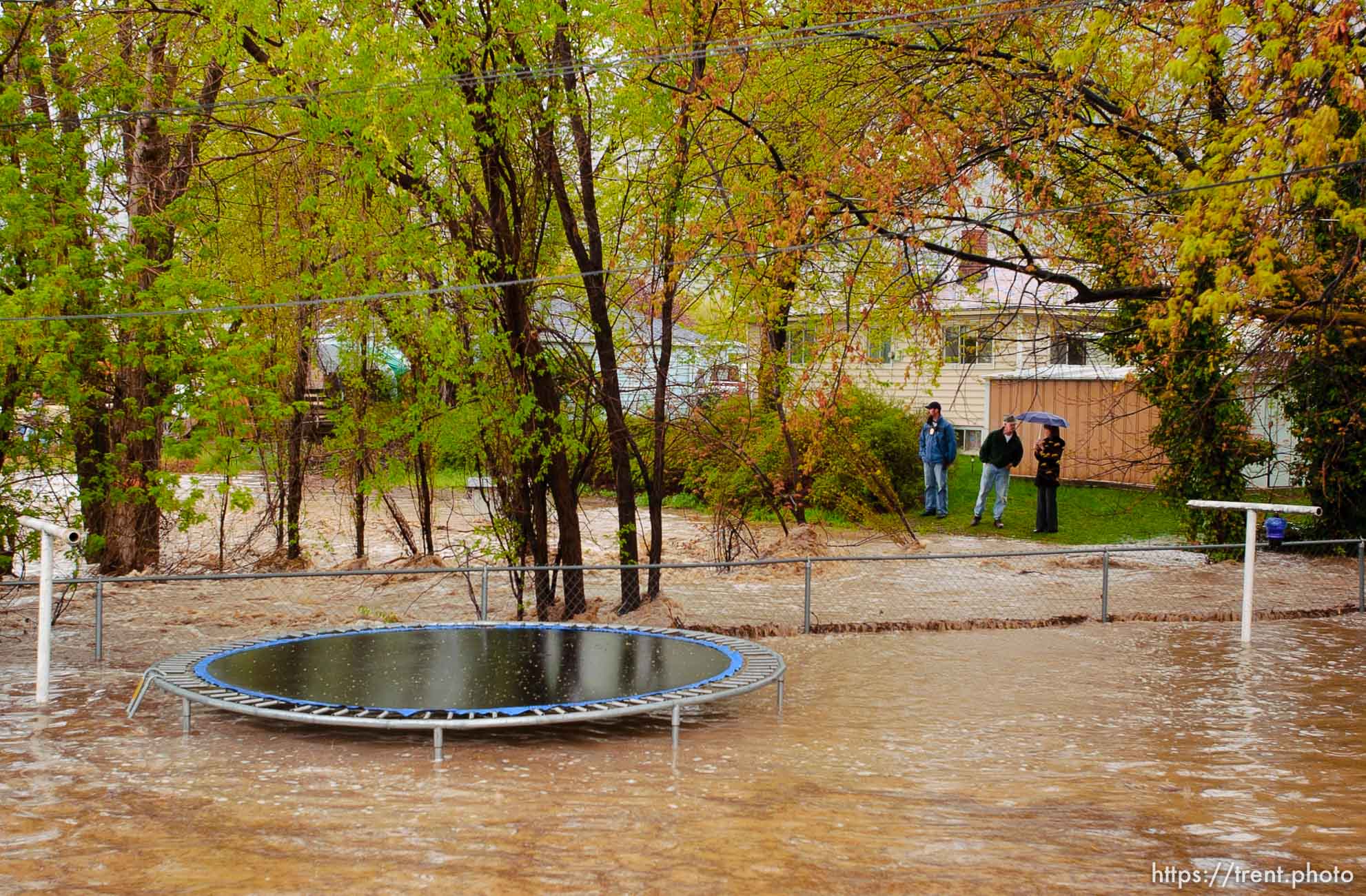 Volunteers work to save the Brigham City home of Linda and Arlin Kay as rain and melting snowpack raise the levels of Box Elder Creek and the Logan River. flood