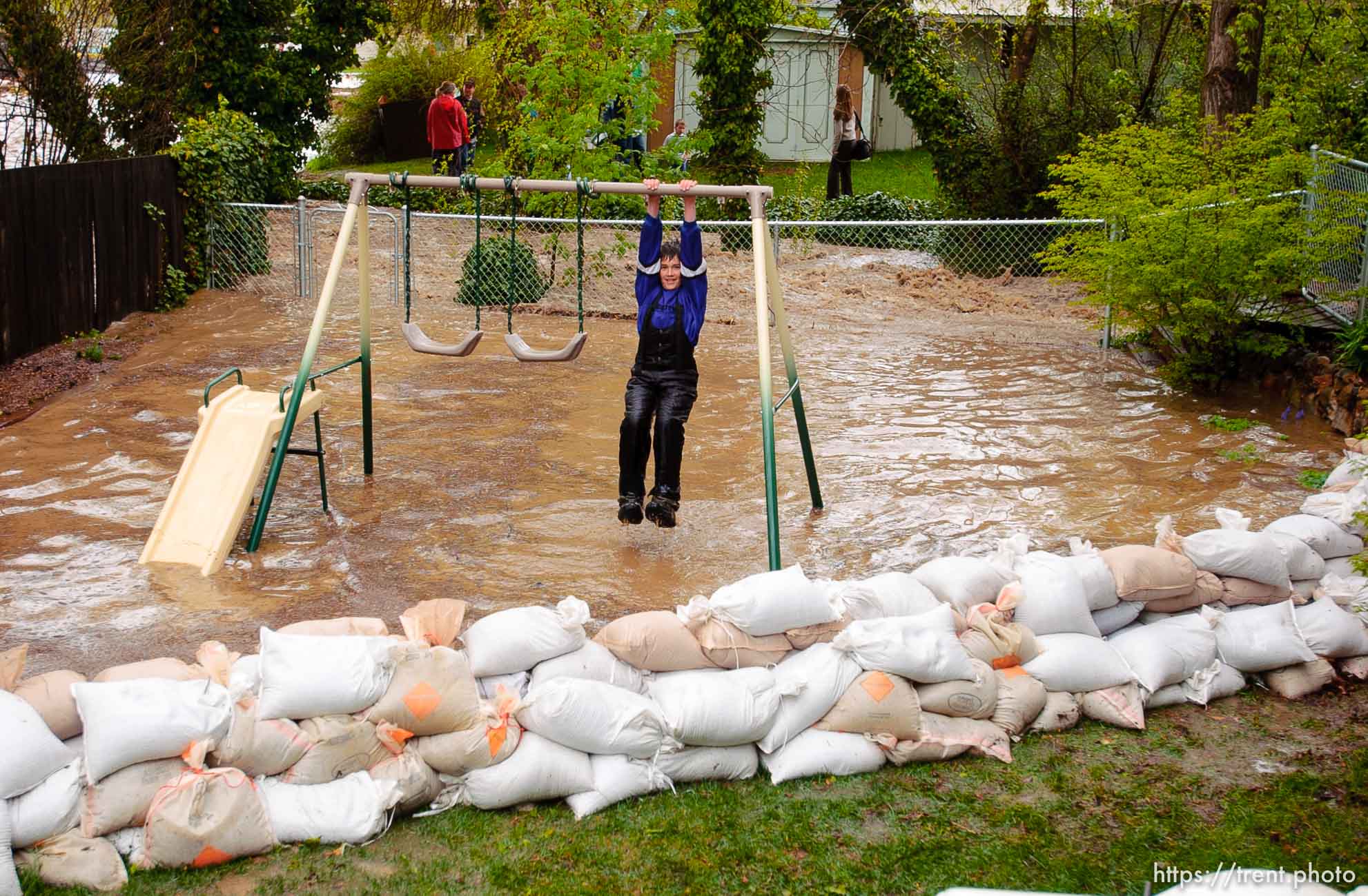 Volunteers work to save the Brigham City home of Linda and Arlin Kay as rain and melting snowpack raise the levels of Box Elder Creek and the Logan River. flood