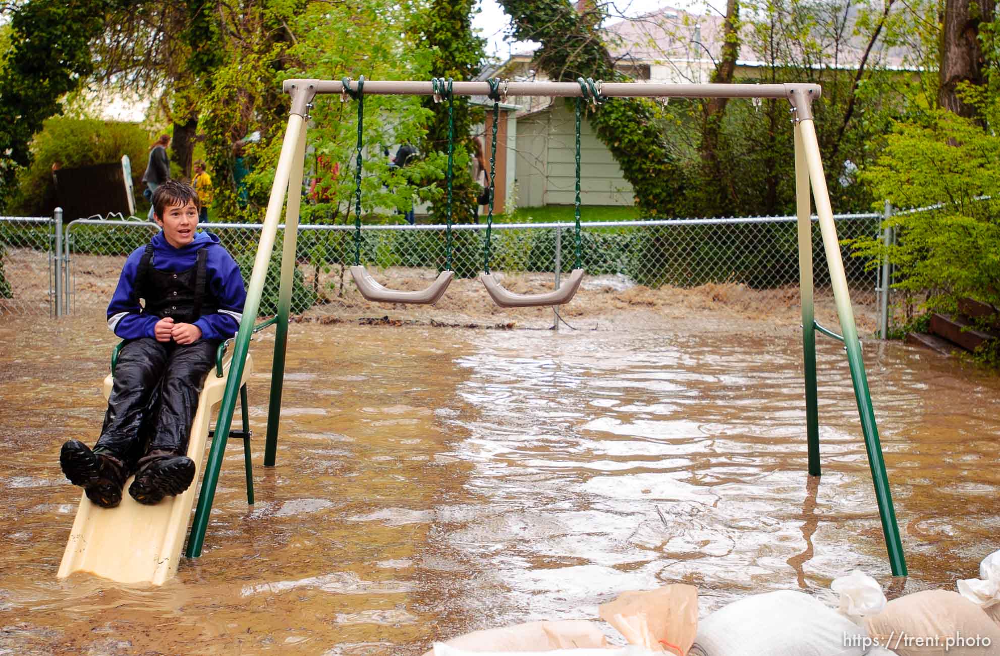 Volunteers work to save the Brigham City home of Linda and Arlin Kay as rain and melting snowpack raise the levels of Box Elder Creek and the Logan River. flood