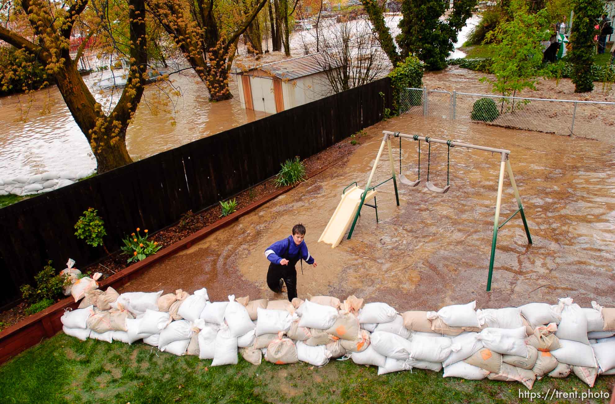 Volunteers work to save the Brigham City home of Linda and Arlin Kay as rain and melting snowpack raise the levels of Box Elder Creek and the Logan River. flood