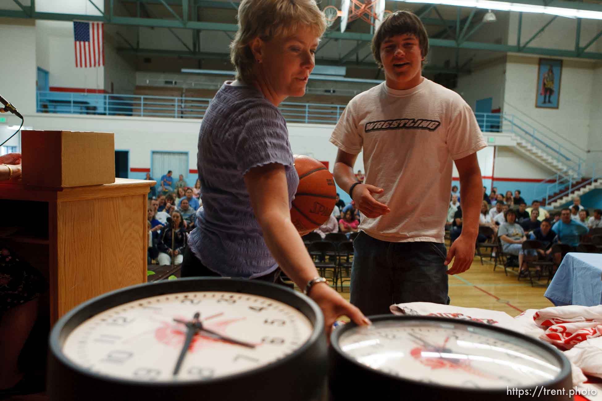 School counselor Karee Hunt, left, helps run a raffle as the school year ends. Students (like Curtis Huitt, right) won prizes including clocks from the school's classrooms and basketballs with the school's logo. The small town of Sunnyside's East Carbon High School is being closed. The students will be transfered to Price's Carbon High School, a 25-minute bus ride away..