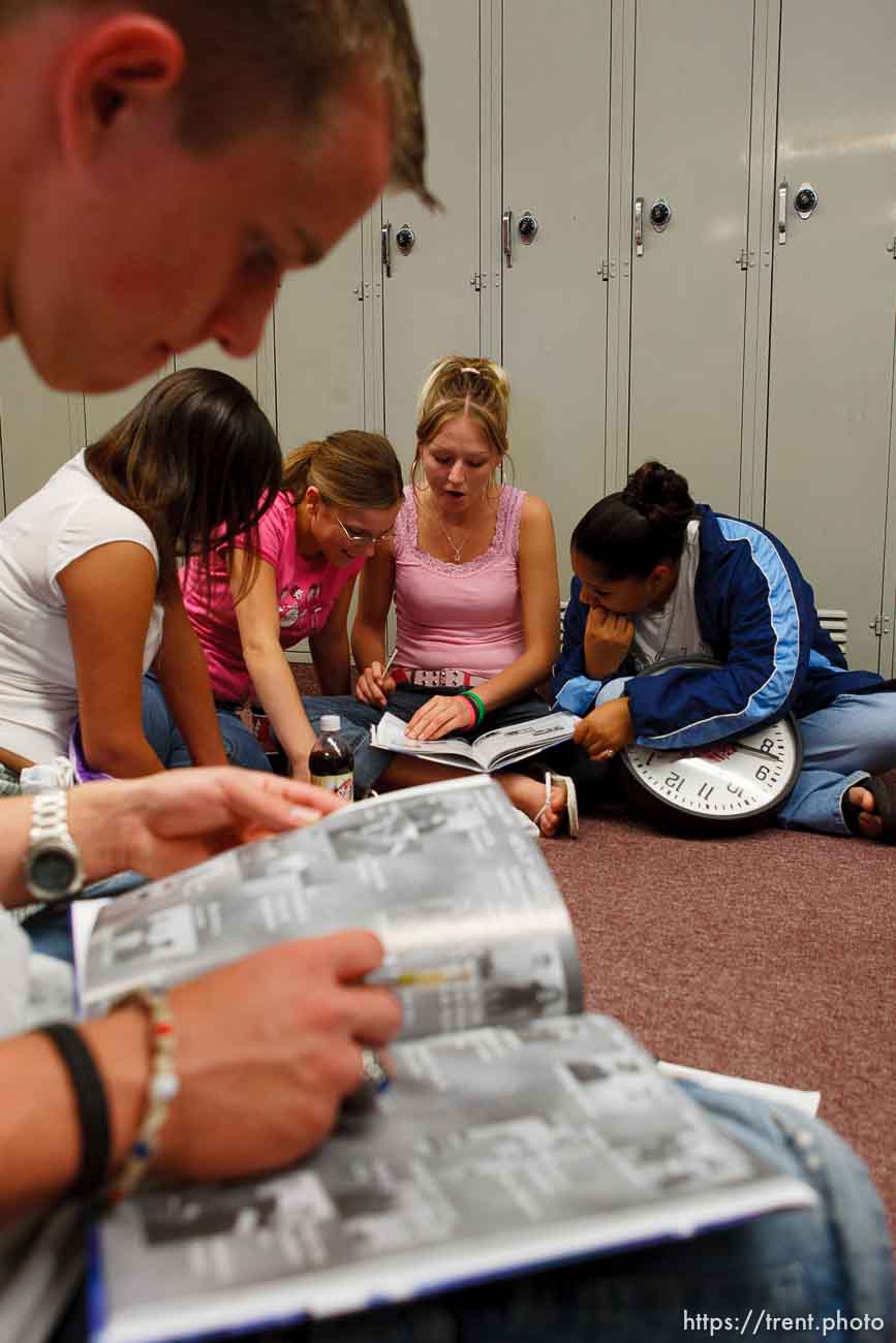 Students signing yearbooks at East Carbon High School. David Stewart (top), then left to right- Michelle Polito, Desiree Huitt, Stephanie Richens, Patricia Hernandez. The small town of Sunnyside's East Carbon High School is being closed. The students will be transfered to Price's Carbon High School, a 25-minute bus ride away..