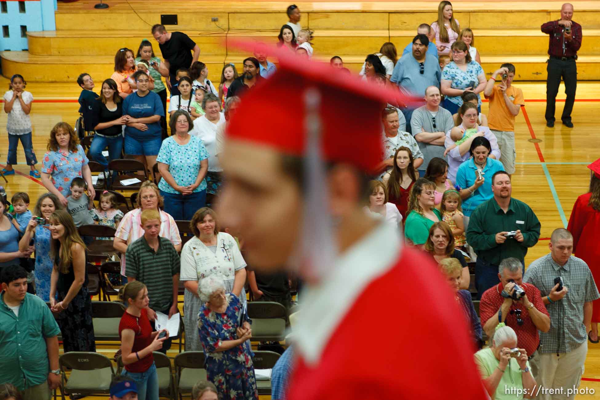 Family and friends fill the East Carbon High School gymnasium as the class of 2005 graduation ceremony begins. Walking in the procession is Cody Valdez.