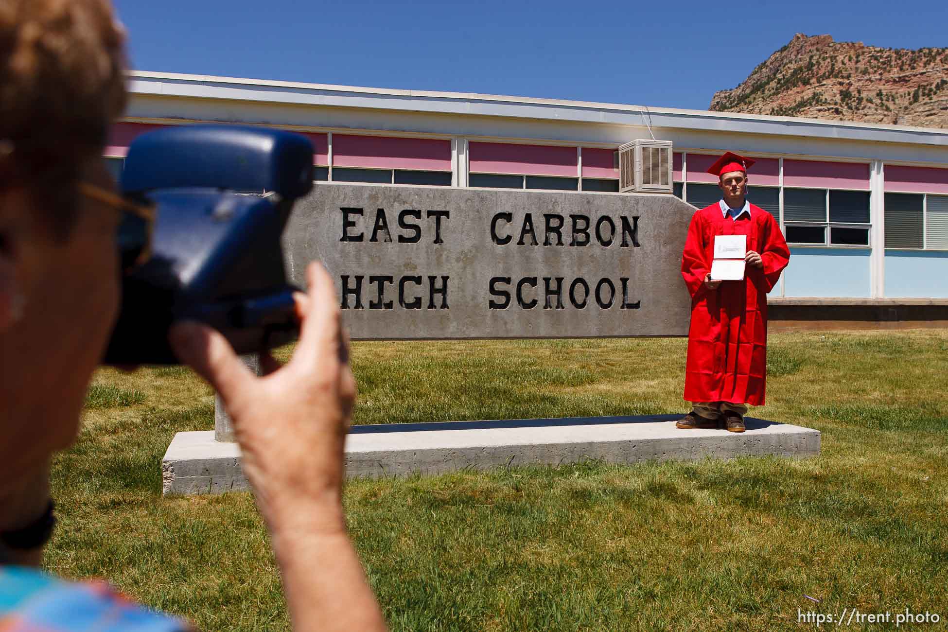 ECHS graduate Justin Ward has his photo taken by his grandmother Betty Marx in front of the school.