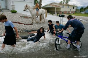 Kids playing in flood water. Flooding along 700 South in Tooele Tuesday. Todd Collins, Jeze Lords, Jesse Riddle, David Lords, and Daniel Lords