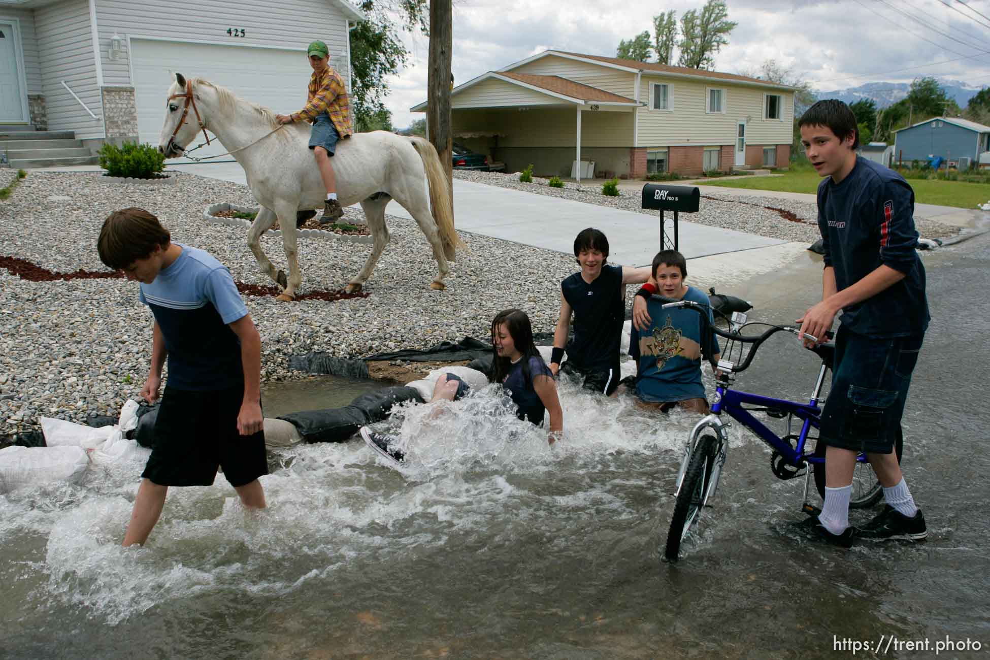 Kids playing in flood water. Flooding along 700 South in Tooele Tuesday.Todd Collins, Jeze Lords, Jesse Riddle, David Lords, and Daniel Lords