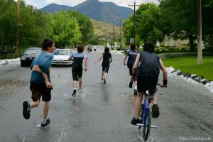 Kids playing in flood water. Flooding along 700 South in Tooele Tuesday.