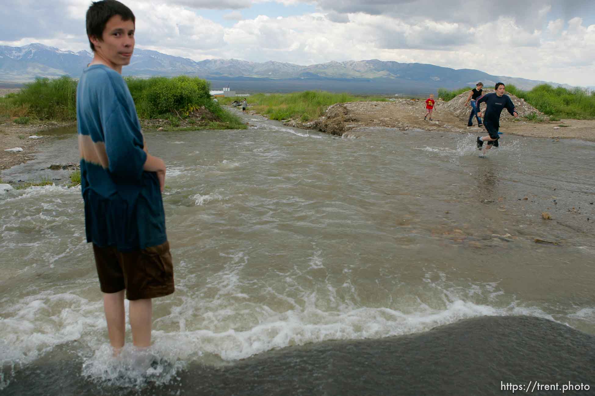 Kids playing in flood water. Flooding along 700 South in Tooele Tuesday.