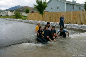 Kids playing in flood water. Flooding along 700 South in Tooele Tuesday.