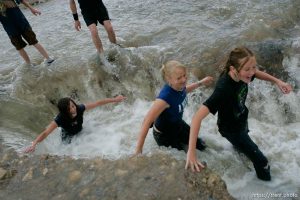 Kids playing in flood water. Flooding along 700 South in Tooele Tuesday. Jeze Lords, Kelsey Bringard and Amanda Hager